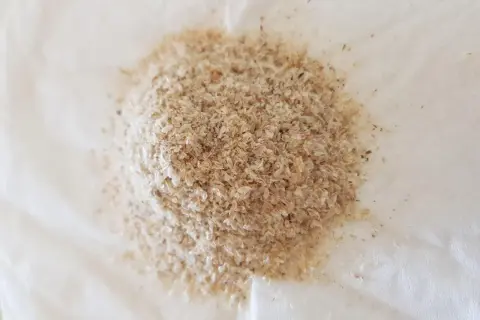 En hög med psyllium husk kapslar, ett naturligt kostfiber som kan hjälpa till med matsmältningen.