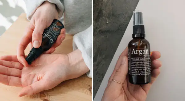 Händer applicerar arganolja hår för glans och näring. Flaskan med ekologisk kallpressad arganolja visas.