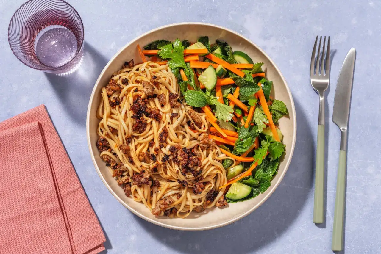 En skål med vietnamesisk mat: nudlar med köttfärs och en fräsch sallad med gurka, morötter och mynta.